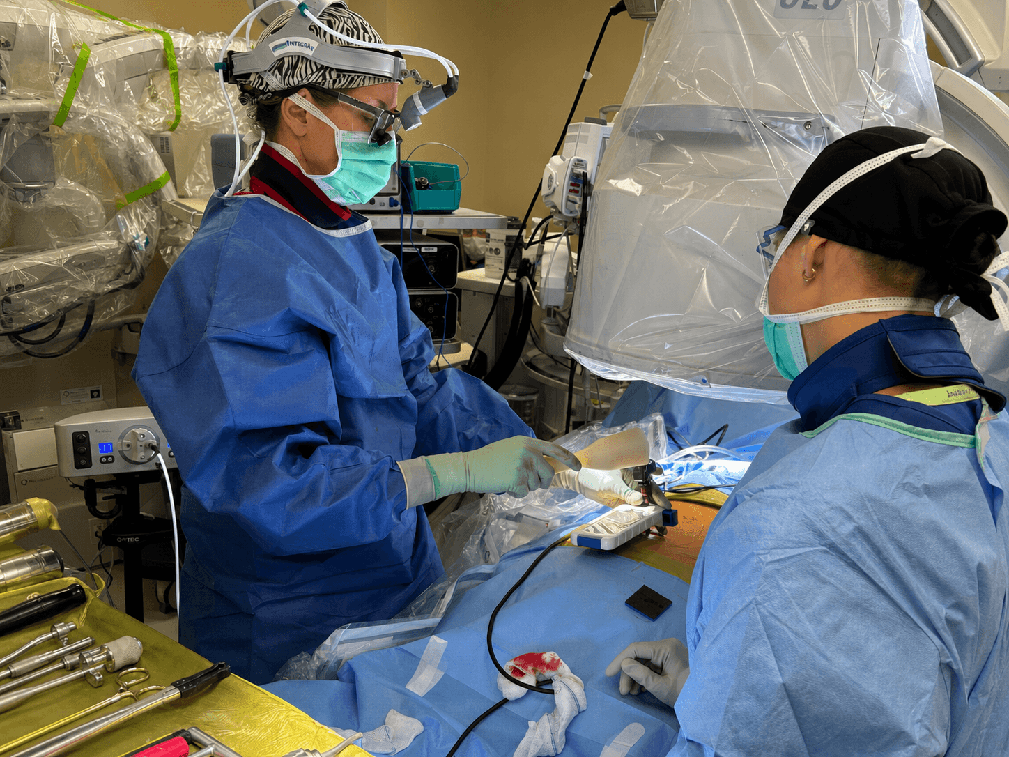 A surgeon guiding pedicle screw placement with the Bolt Navigation Unit