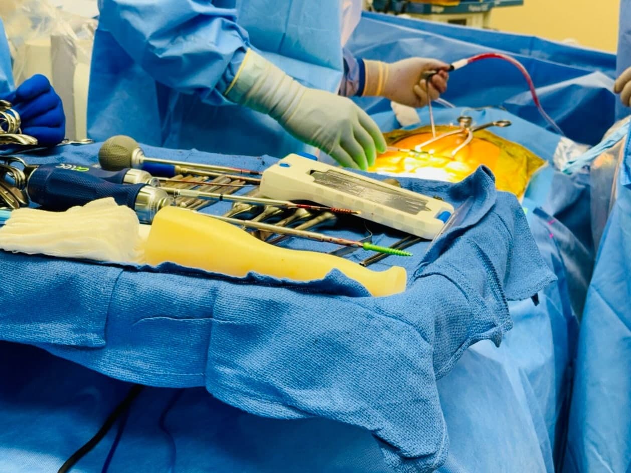 Surgical instruments and the Bolt Navigation Unit staged on the OR table