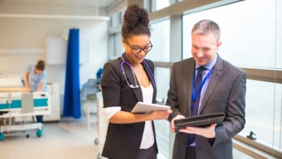 hospital administrator team having a conversation in the hallway