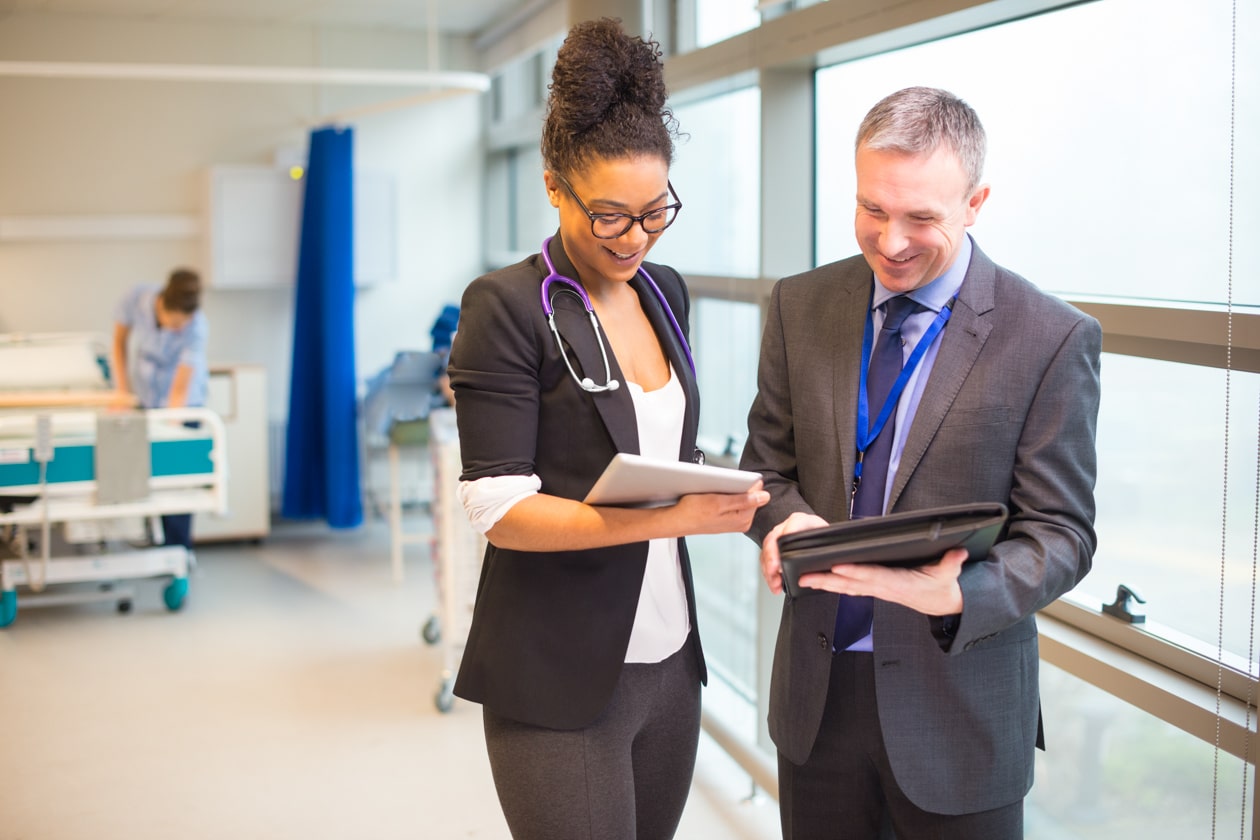 hospital administrator team having a conversation in the hallway
